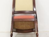 an image of a wooden chair with a yellow and red seat
