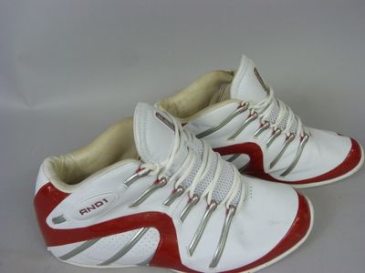 pair of red and white tennis shoes on a white surface