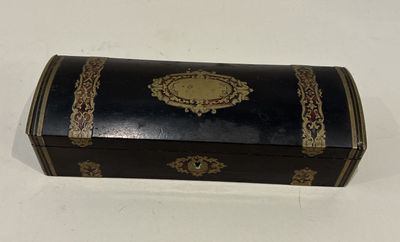an old black and gold box with a gold trimming on it