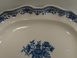 a blue and white plate with a bouquet of flowers on it