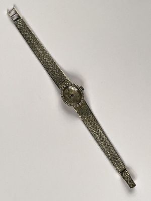 an image of a wrist watch on a white surface with a white background