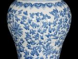 a blue and white vase with a floral design on it