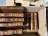 a box full of old books sitting on top of a table