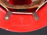 a close up of a red hat with a rope around it