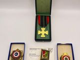three medals are in a box on a white surface
