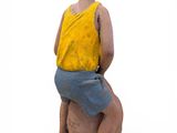a figurine of a boy sitting on a ball