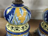 two vases that are sitting on a wooden table