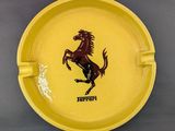 yellow ferrari ashtray ashtray with a black horse on it