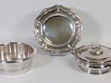 three pieces of silverware including a bowl, saucer and saucer