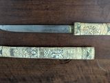 two knives that are sitting on a wooden table