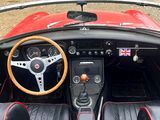 a red and black car with a steering wheel and dashboard