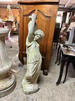 a statue of a boy holding a bird in his hand