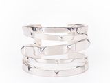 a close up of a stack of silver rings on a white background