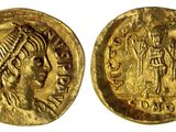 une pièce d'or à l'effigie d'une femme portant une coiffe