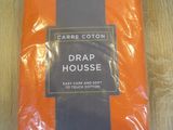 a close up of a package of orange and black bedding