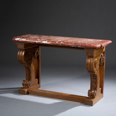 an old wooden table with a marble top on a gray surface