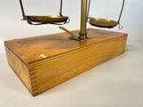 an image of a scale on a wooden stand with a white background