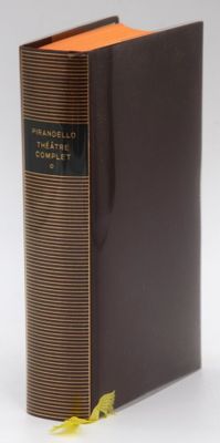 an old book sitting on top of a table next to a yellow ribbon