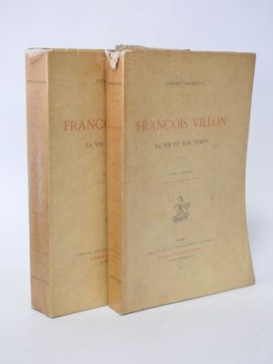 two books sitting on top of each other on a white surface