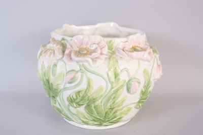 a white vase with pink and green flowers painted on it