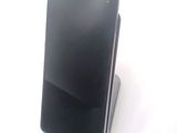 a cell phone that is sitting on top of a stand
