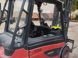 a red fork truck that is parked in a parking lot