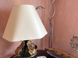 a small table with a lamp and a bowl on it