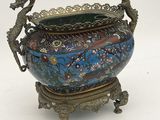 a blue vase with a dragon on it on a stand