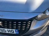 a close up of a car ' s front grill with a number plate on it
