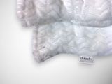a white teddy bear with a tag on it ' s neck