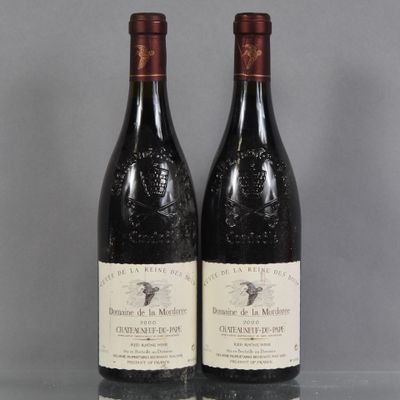 two bottles of wine sitting on top of a table next to each other
