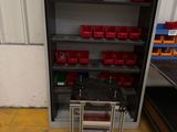 a metal shelf with red bins on top of it
