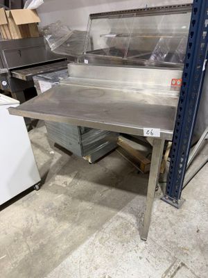 a metal table that is sitting in the middle of a room
