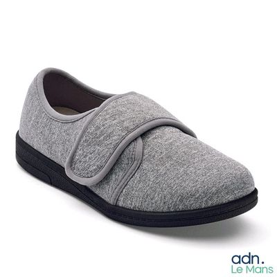 grey slip on shoes with black soles on a white background