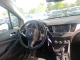 a steering wheel and dashboard of a car in a parking lot