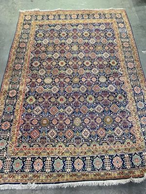 an antique persian rug with blue and red colors