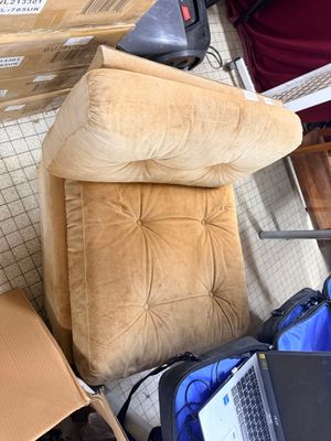 a couch and a laptop on the floor in a room