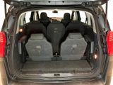 four seats in the back of a car with luggage in the trunk