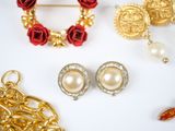 many different types of jewelry on a white surface