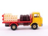 a toy truck with barrels on the back of it