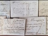 several pieces of paper with writing on them sitting on a table