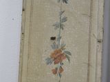painting on the wall of a room with a flower design on it