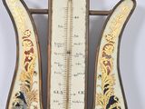 an old fashioned thermometer on a wooden stand