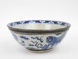 a blue and white bowl sitting on a white surface