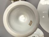a cup and saucer sitting on a table next to a plate
