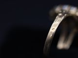 close up of a diamond ring on a black surface
