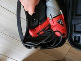 a person holding a tool in a case on the floor
