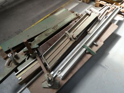 several pieces of metal sit on top of a pallet in a warehouse