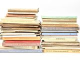 many books stacked on top of each other on a table