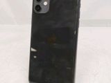 the back of a black iphone 11 with a charging dock on a white surface